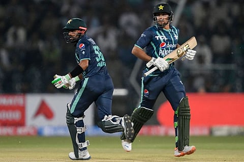 Pakistan's captain Babar Azam (left) with teammate Haider Ali run between the wickets during the sixth Twenty20 international against England at the Gaddafi Cricket Stadium in Lahore.