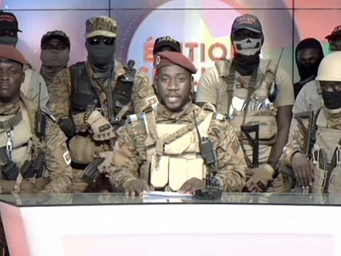 In this image from video broadcast by RTB state television, coup spokesman Capt. Kiswendsida Farouk Azaria Sorgho reads a statement in a studio in Ougadougou, Burkina Faso, on September 30, 2022.  