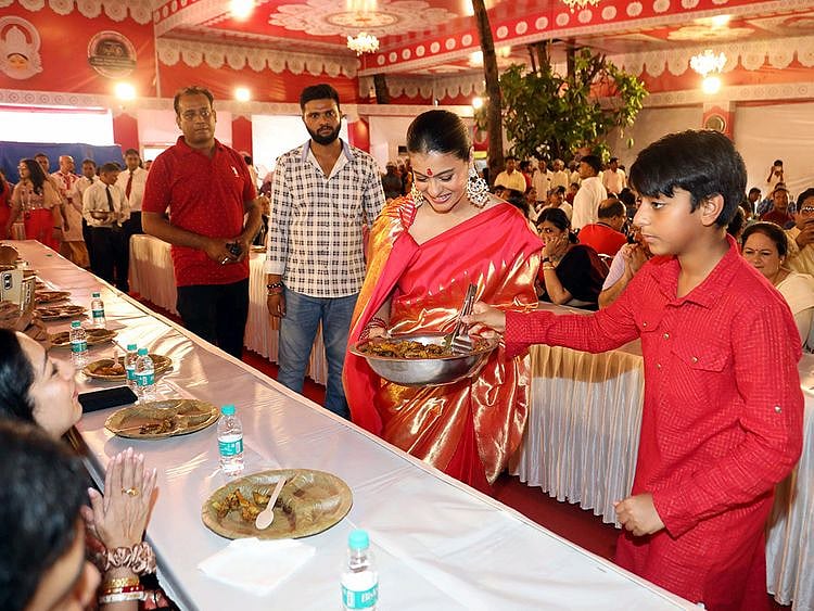 Bollywood actress Kajol with her son Yug Devgn serving Bhog at Durga Puja festival celebration, in Mumbai on Sunday.