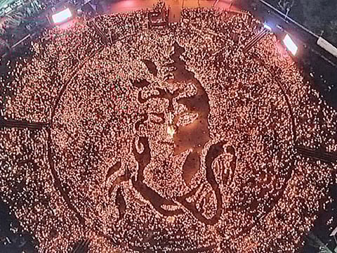 A drone shot shows thousands of people at Cultural Navratri garba ground in State capital Gandhinagar, Gujarat creating a figure of Bhagwan Shiv by using oil lamps on Monday night.