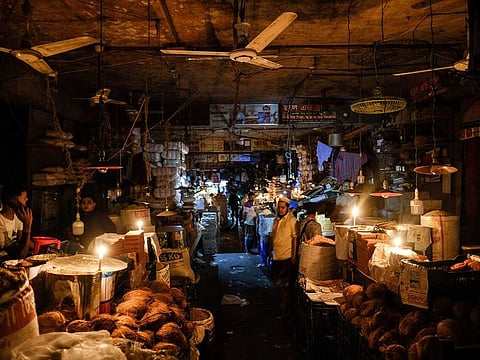 Vendors light candles at a market after a failure in Bangladesh's national power grid plunged much of the country into a blackout in Dhaka, Bangladesh, Tuesday, Oct.4, 2022. 