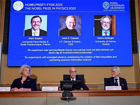 Secretary General of the Royal Swedish Academy of Sciences Hans Ellegren, Eva Olsson and Thors Hans Hansson, members of the Nobel Committee for Physics announce the winners of the 2022 Nobel Prize in Physics Alain Aspect, John F. Clauser and Anton Zeilinger, during a news conference at The Royal Swedish Academy of Sciences in Stockholm.