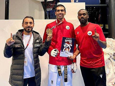 Sinan Ashfaq Ahmed (centre) with his coach Abdullah Hatim (left) after winning the gold medal at the Albania Open Taekwondo Championship in Tirana on October 1.