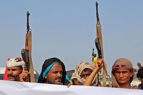 Militants gather for a protest against Yemen's Al Houthi militia in the Khokha region of the country's war-ravaged western province of Hodeida. 