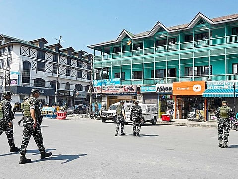 Indian paramilitary troopers patrol along a street in Srinagar on October 4, 2022, during India's Home Minister Amit Shah's visit to Jammu and Kashmir.