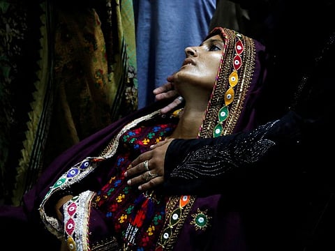Koonjh, 25, a flood-affected woman and suffering from fever, is taken care by a relative as she waits for medical assistance at Sayed Abdullah Shah Institute of Medical Sciences in Sehwan.  