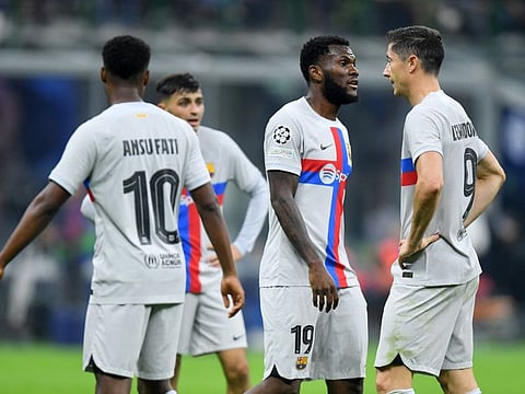 FC Barcelona's Robert Lewandowski, Ansu Fati and Franck Kessie react after losing the Champions League Group C match against Inter Milan at San Siro in Milan on Tuesday.