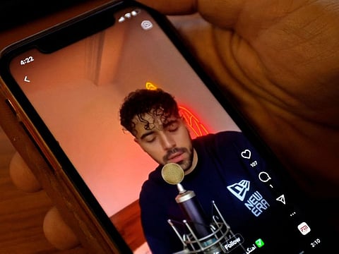 A man watches a video of Iranian singer Shervin Hajipour, who was released in Tehran after being arrested for his song in support of protests over the death of Mahsa Amini, in the Cypriot capital Nicosia on October 4, 2022.  