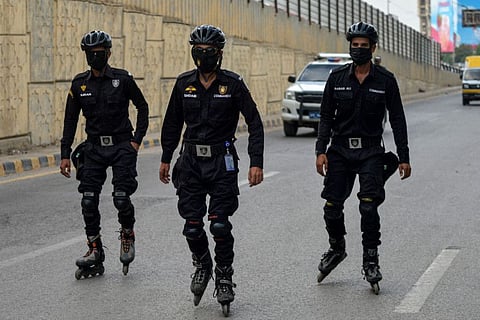 Police wearing skates patrol along a street in Karachi on September 22, 2022. The ECP asked the government to redeploy police to Karachi polling stations for the smooth conduct of the polls.