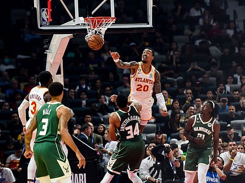 John Collins of Atlanta Hawks nets against Milwaukee Bucks during their NBA game at Ethad Arena in Abu Dhabi.