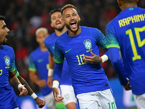 Brazil's forward Neymar (centre) celebrates after scoring his team's third goal during the friendly against Tunisia at the Parc des Princes in Paris on September 27.