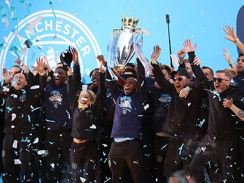 Manchester City's Fernandinho and teammates celebrate with the Premier League trophy during the victory ceremony in Manchester in May. The coveted trophy will be touring the UAE this month.