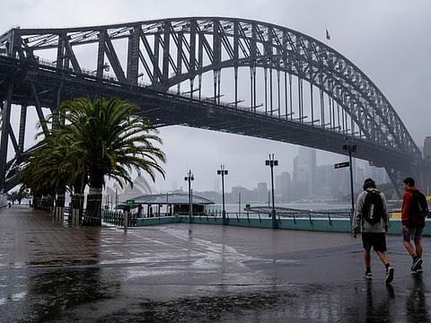Commuters walk to a ferry in Sydney, Australia, Thursday, Oct. 6, 2022. Sydney notched up its wettest year in over 160 years of records, Weatherzone's Andrew Miskelly said, recording 2199.8mm at 1.10pm.