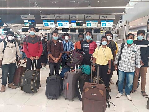 Indian workers rescued after they were lured by agents for fake job opportunities in the information technology sector in Thailand arrive at the airport in Chennai.