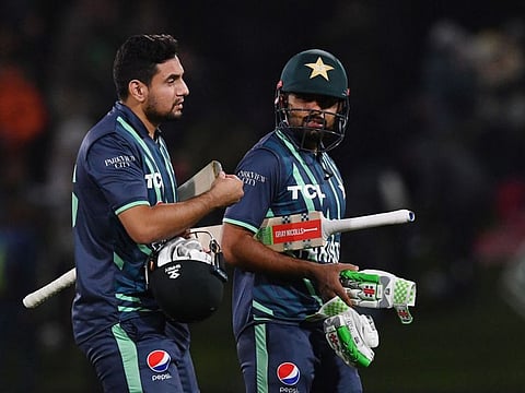 Pakistan's Babar Azam (right) and Haider Ali walk off the field after their victory in the second match against New Zealand of the Twenty20 tri-series at Hagley Oval in Christchurch.