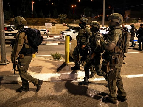 Israeli soldiers patrol the area following a shooting incident at a check point in East Jerusalem, Israeli police said October 8, 2022.
