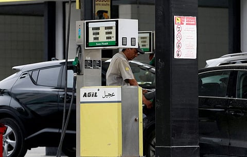 A gas station attendant pumps fuel into a customer's car at a gas station in Tunis, Tunisia June 1, 2018.
