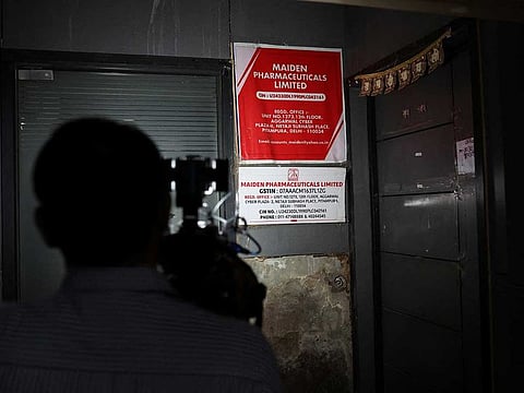 A cameraman takes visuals outside the office of Maiden Pharmaceuticals Ltd. company, in New Delhi, India, October 6, 2022. 