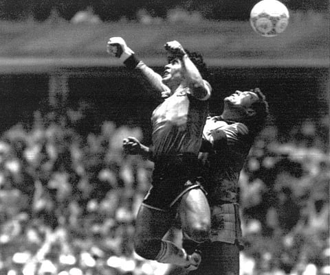 Argentina's Diego Maradona (left) beats England goalkeeper Peter Shilton to a high ball and scores his first of two goals in a World Cup quarter-final in Mexico City on June 22, 1986.