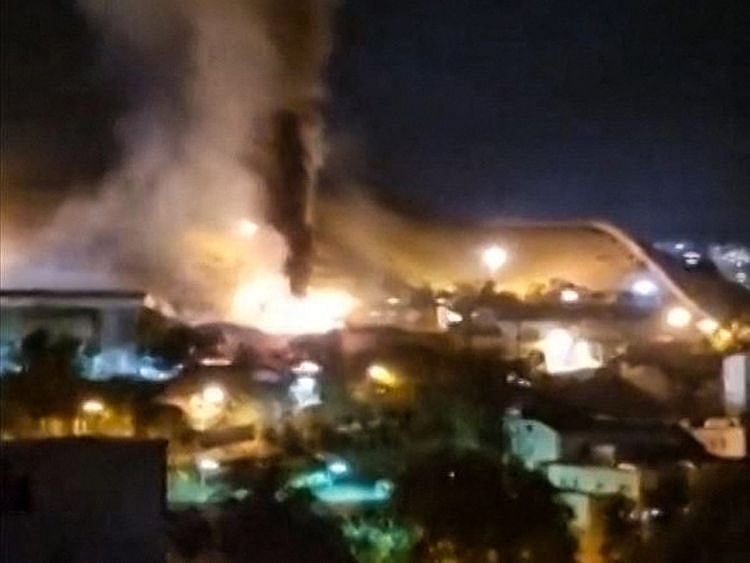 This image grab from a UGC video made available on October 15, 2022, reportedly shows flames and thick smoke rising from the Evin prison, in the northwest of the Iranian capital Tehran.  