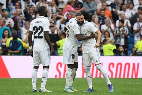 Real Madrid's players celebrate victory after the Spanish League match against FC Barcelona at the Santiago Bernabeu stadium in Madrid.