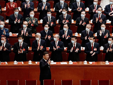 Chinese President Xi Jinping waves as he arrives for the opening ceremony of the 20th National Congress of the Communist Party of China, at the Great Hall of the People in Beijing on October 16, 2022.  