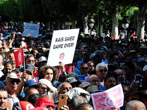 People take part in a demonstration by the National Salvation Front against President Kais Saïed at Avenue Habib Bourguiba in Tunis.