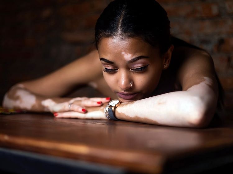 Woman resting her head on a table 