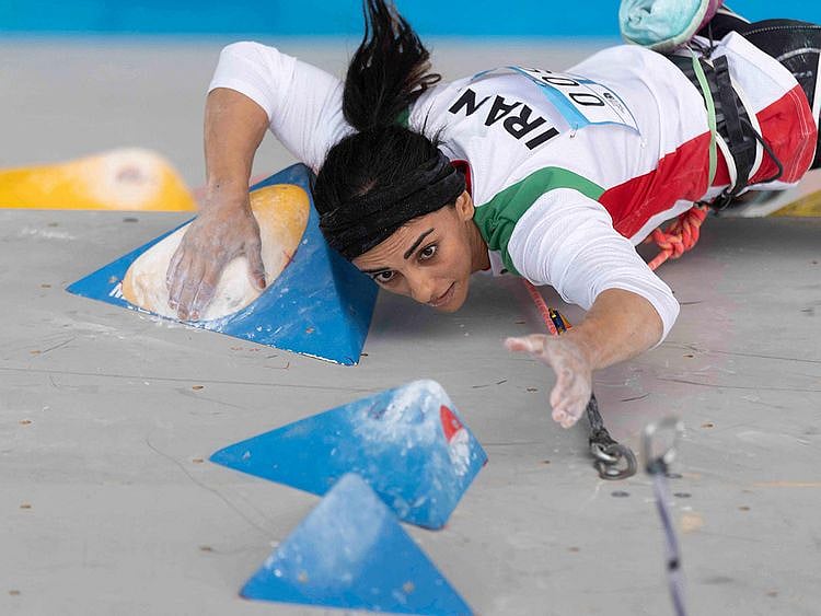 A handout picture provided by the International Federation of Sport Climbing (IFSC) shows Iranian climber Elnaz Rekabi competing during the women boulder finals of the Asian Championships of the IFSC in Seoul, South Korea.