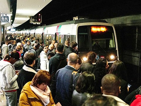 Passengers wait to board a congested train during a national strike at Gare du Nord train station in Paris, France, on Tuesday, Oct. 18, 2022.  