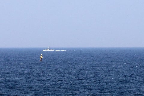 In this file photo taken from the Lebanese southernmost area of Naqura on October 3, 2022, an Israeli military boat patrols Mediterranean waters around a border-marking buoy between the two countries.  