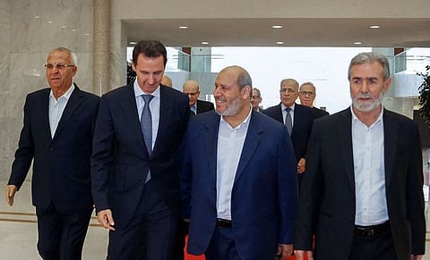 Syria's President Bashar al-Assad (second left) receiving the leader of Palestinian militant group Islamic Jihad, Ziad Al Nakhala (right), Hamas chief of Arab relations, Khalil Al Hayya (second right) and secretary general of the Popular Front for the Liberation of Palestine, Talal Naji (left), in Damascus, on October 19, 2022. 