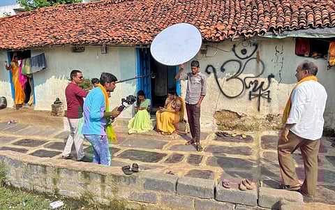 Residents film fellow villagers as they enact a scene for a social drama that they are making for their YouTube channel in Tulsi village in the central state of Chhattisgarh.