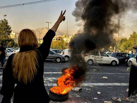 Iranians protests the death of 22-year-old Mahsa Amini after she was detained by the morality police, in Tehran.