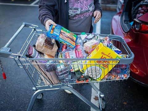 A customer packs shopping into the boot of a car at an Aldi Stores Ltd. supermarket in Sheffield, UK.