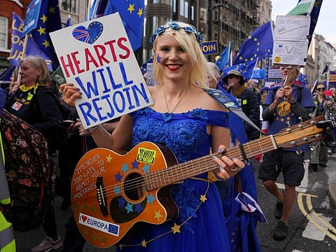 Protesters take part in a march calling for Britain to rejoin the European Union, in London, on October 22, 2022.  A lot of Britons are beginning to wonder why they are not getting a chance to influence who is their next leader.