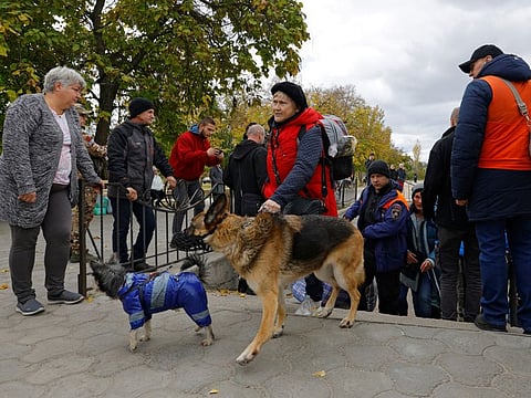 Civilians evacuated from Kherson disembark a ferry as they arrive in the town of Oleshky, on October 22, 2022. 