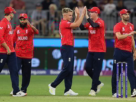 England bowler Sam Curran is congratulated by teammates during the T20 World Cup cricket match between England and Afghanistan in Perth, Australia. England won by 5 wickets.
