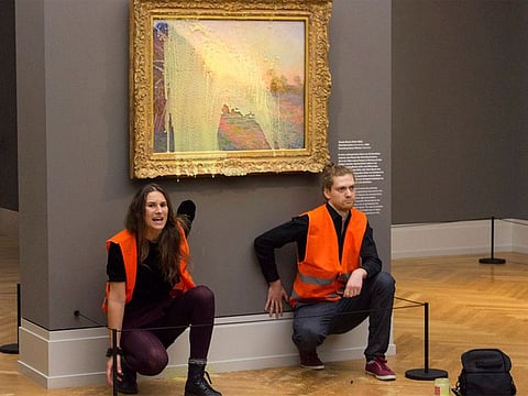 Climate protesters of Last Generation after throwing mashed potatoes at the Claude Monet painting 'Les Meules' at Potsdam’s Barberini Museumto protest fossil fuel extraction.