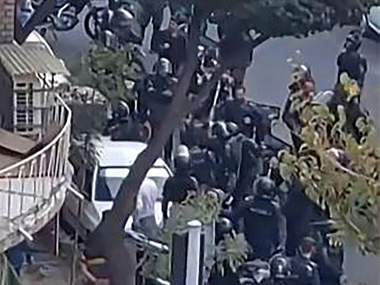 This image grab from a UGC video shows Iranian security forces gathering outside the Shahid Sadr Girls high school in Tehran.  