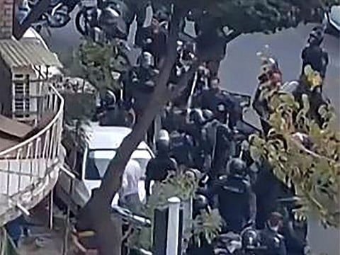 This image grab from a UGC video shows Iranian security forces gathering outside the Shahid Sadr Girls high school in Tehran.  
