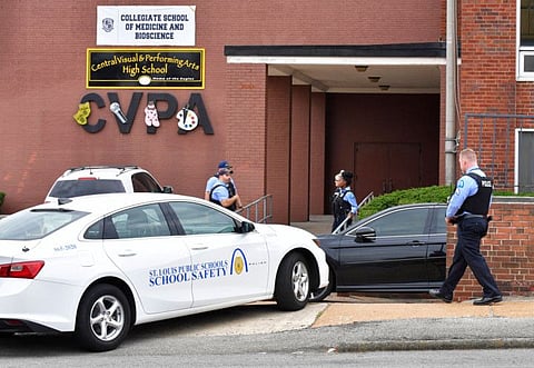 St. Louis metropolitan police officers stand outside an entrance at the northeast corner of the Central Visual and Performing Arts High School after a shooting that left three people dead including the shooter in St Louis, Missouri on October 24, 2022.