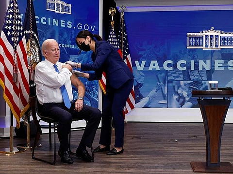 US President Joe Biden receives an updated coronavirus disease (COVID-19) vaccine while launching a new plan for Americans to receive booster shots and vaccinations, onstage in an auditorium on the White House campus in Washington, U.S. October 25, 2022. 