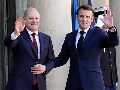 French President Emmanuel Macron, right, welcomes German Chancellor Olaf Scholz at the Elysee Palace in Paris, Wednesday, Oct. 26, 2022.