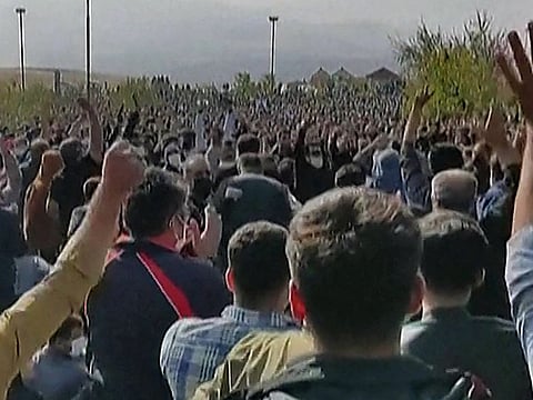This image grab from a UGC video released on October 26, 2022 shows hundreds of protesters clapping and cheering during a rally in Saqez, Mahsa Amini's hometown in IRan's western Kurdistan province, on the 40th day since her death. 