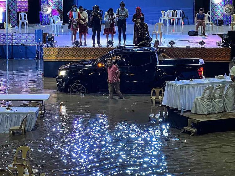 Residents trapped inside a gym in the town of Upi in Maguindanao province, southern Philippines, which was flooded after heavy rains brought about by tropical storm Nalgae. 