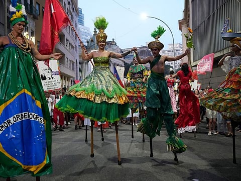 Revellers dance during a street party to celebrate the birthday of Brazil's former President Luiz Inacio Lula da Silva, who is running for president again, at Cinelandia square in Rio de Janeiro, on October 27, 2022.  