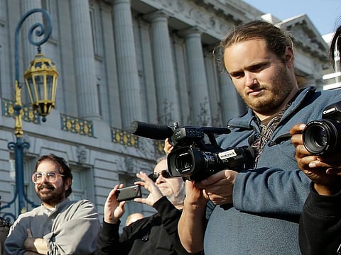 David DePape, right, records a wedding of Gypsy Taub outside City Hall on December 19, 2013, in San Francisco.  