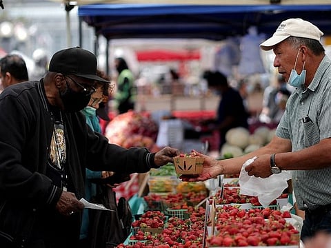 A resident buys strawberries at a local market, in downtown San Francisco, California, U.S., July 13, 2022. 