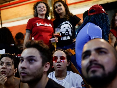 People observe a debate ahead of the runoff election between Brazil's President and candidate for re-election Jair Bolsonaro and former President and current candidate Luiz Inacio Lula da Silva, at a bar in Brasilia, Brazil October 28, 2022.  